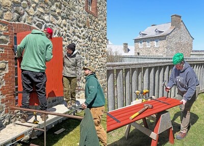 Left Image: Caption: Algonquin College Heritage Carpentry students Kyle Cobus and Isabelle Dudzinski install a shutter on a historical building at the Fortress of Louisbourg National Historic Site, under the guidance of Parks Canada staff member Danny MacNeil. Right Image: Caption: Algonquin College Heritage Carpentry student Tristan Webber fastens a bracket to a shutter by hammering a square-head nail at the Fortress of Louisbourg National Historic Site. (CNW Group/Parks Canada (HQ))