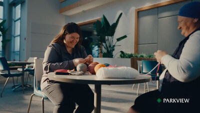 Parkview team member and patient Azra crochet together.