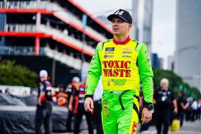 NASCAR driver, Brennan Poole, appearing at the 2025 Chicago Street Race dressed in a Toxic Waste Sour Candy branded fire suit.
