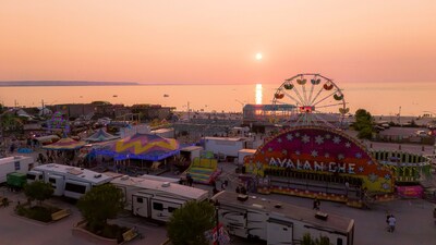 The sun goes down at Wasaga Beach during the Town's annual midway, which takes place each summer on the shores of the longest freshwater beach in the world. This summer's midway takes place between July 24 and 27, 2025. (CNW Group/Town of Wasaga Beach)