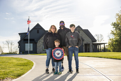 John Kremer, U.S. Navy Petty Officer 1st Class (Retired) and family in front of their new R.I.S.E. home.