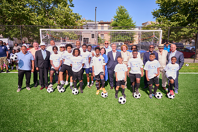 Representatives from Children's Hospital of Philadelphia, Embassy of the United Arab Emirates, Philadelphia Parks and Recreation, gather with community members to celebrate the opening of Conestoga Park soccer field in West Philadelphia. 
