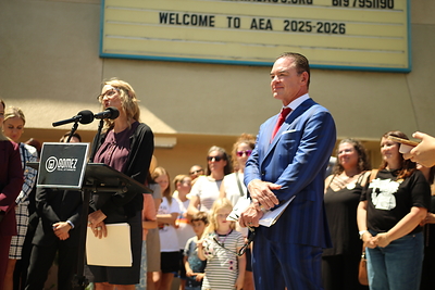 Attorney John Gomez stands alongside client Margaretta Boutserse during a press conference outside Albert Einstein Academies in San Diego on June 12, 2026. Boutserse, a former principal at the school, spoke publicly about her whistleblower retaliation and wrongful termination lawsuit as supporters, educators, parents, and community members gathered in attendance.