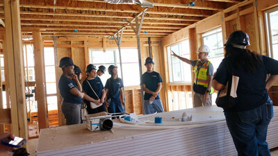 Ken Hesse, Superintendent, Brookfield Residential, leads Pasadena Unified School District student participants through an active homebuilding site, providing an inside look at residential construction.