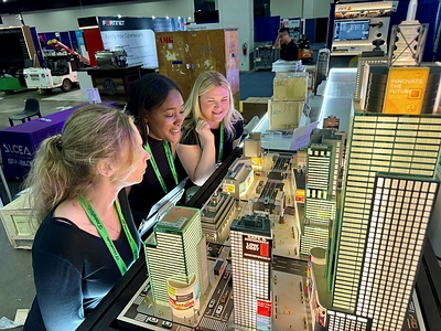Visitors explore LEOTEK’s smart city demonstration at ITS America 2026.
