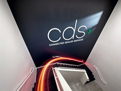 A branded stairwell inside Connected Dealer Services’ new Irvine headquarters showcases updated workspace design created to support collaboration, employee engagement, and continued company growth.