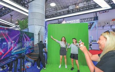 Visitors experience green screen digital products during the 14th China International Digital Publishing Expo in Haikou, Hainan province, on Sept 21, 2024.