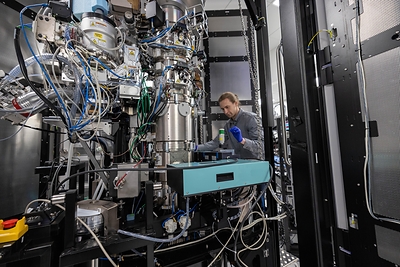 Biohub engineer Pavel Olshin makes adjustments to the laser phase plate cavity inside a cryo-electron microscope. (Credit: Dale Ramos/Biohub)