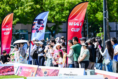 A large crowd of spectators gathers to cheer on competitors at The Woof Cup 2026, the first pet soccer games.