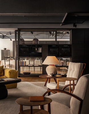 Seamless Integration: V-ZUG appliances are seamlessly concealed behind dark bespoke cabinetry, harmonizing advanced technology with warm residential aesthetics.