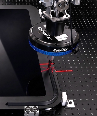 High-speed lasers check the application of adhesives on a vehicle window at the Coherix product development center in Ann Arbor, Michigan.
