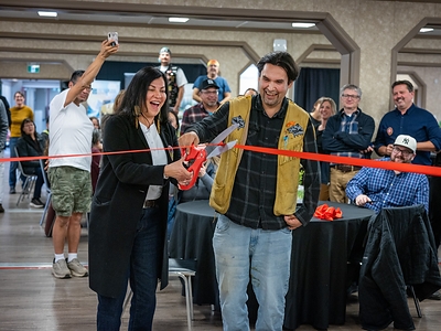 Northern and Arctic Affairs Minister Rebecca Chartrand and Ross River Dena Council Chief Dylan Loblaw cut the ribbon to officially open Tsē Zūl Camp at the opening ceremony held in the camp cafeteria. Credit: Peter Mather and Dena Nezziddi Development Corporation