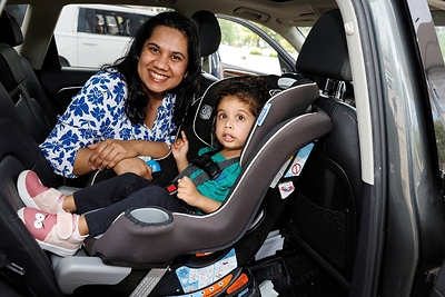 A child properly secured in a car seat poses with her mother during a car seat safety event at Children’s Hospital of Michigan in Troy, Mich., on Sept. 12, 2026. (Photo/Hyundai)