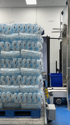 Automatically palletized 7lb bundles conveyed to shrink wrap machine.