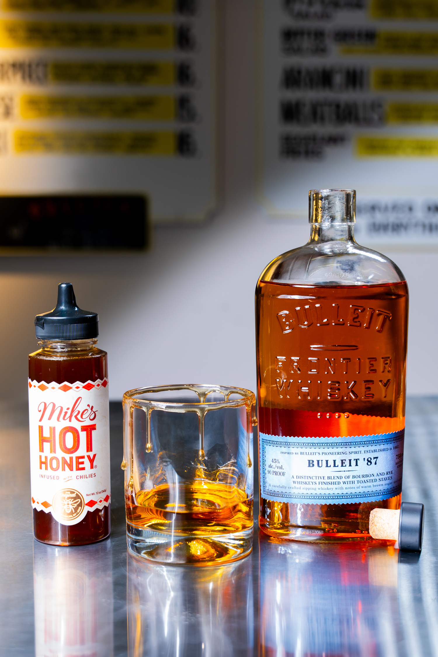 The Kentucky Hot Shot serve, a neat pour of Bulleit '87 Whiskey with a Mike's Hot Honey Rim The Kentucky Hot Shot serve, a neat pour of Bulleit '87 Whiskey with a Mike's Hot Honey Rim