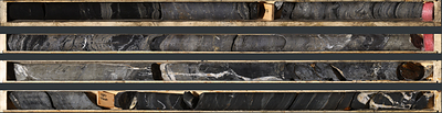 Photo 2: An interval of laminated to semi-massive sulphide mineralization in TS26-005 consisting of laminated to semi-massive sphalerite, galena, barite and black mudstone from 176.3 to 180.8 m Photo 2: An interval of laminated to semi-massive sulphide mineralization in TS26-005 consisting of laminated to semi-massive sphalerite, galena, barite and black mudstone from 176.3 to 180.8 m