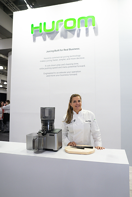 Chef Ana Machado showcases Hurom’s commercial CP50 juicer at the Restaurant Show in New York.